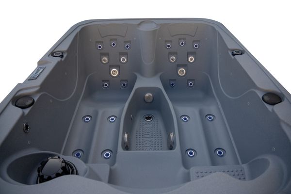 Front interior view of Luso Spas The Rota Triad Hot Tub in dark grey showing dual recliners and multiple massage jets on a white background.