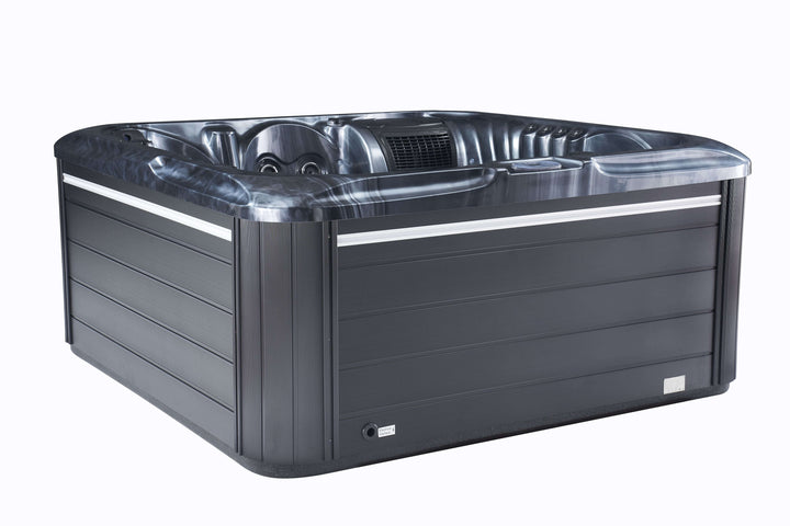 Side view of Luso Spas The Vela Hot Tub in dark grey finish highlighting smooth marble-effect shell and digital control system on a white background.