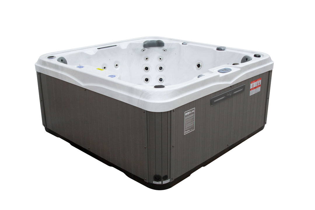 Angled side view of Luso Spas The Venice Hot Tub in white and grey design showing ergonomic seats and exterior paneling, on a white background.