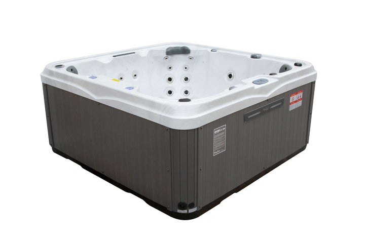 Angled side view of Luso Spas The Venice Hot Tub in white and grey design showing ergonomic seats and exterior paneling, on a white background.
