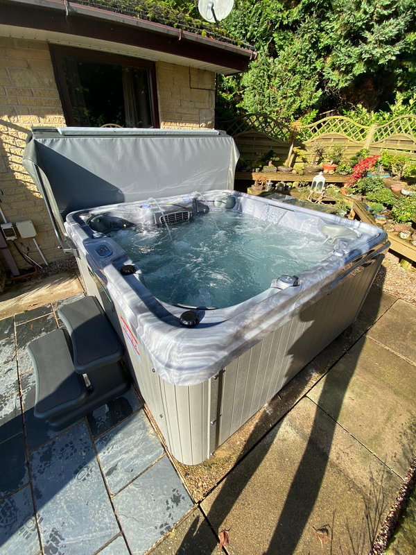 Luso Spas The Venice 2 Hot Tub placed outdoors on a wooden deck with canopy shade and garden background.