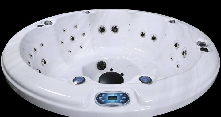 Interior view of Luso Spas The Zodiac Plug & Play Hot Tub showing white acrylic shell, hydrotherapy jets, and Balboa control panel.