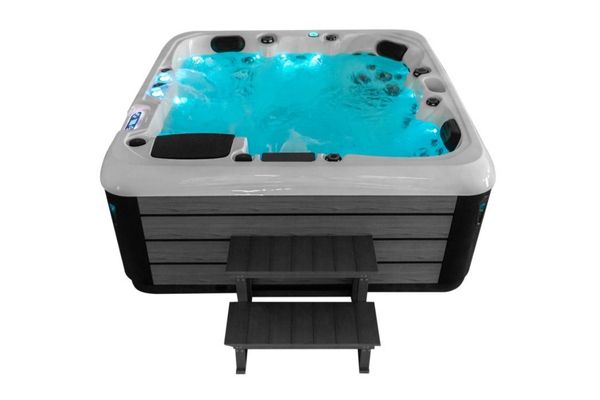 Front view of Luso Spas The Platinum 4 Hot Tub with LED lighting and entry steps, on a white background.