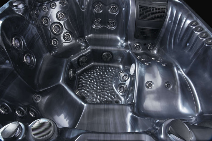 Interior view of Luso Spas The Vela Hot Tub in dark marble finish showcasing powerful jet arrangement and speaker system.