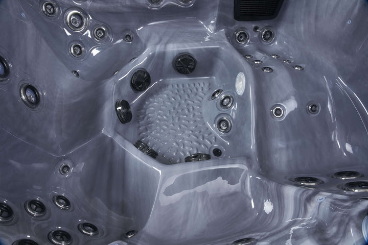 Close-up of Luso Spas The Vela Hot Tub black marble interior showing hydrotherapy jets and contoured seating for comfort.