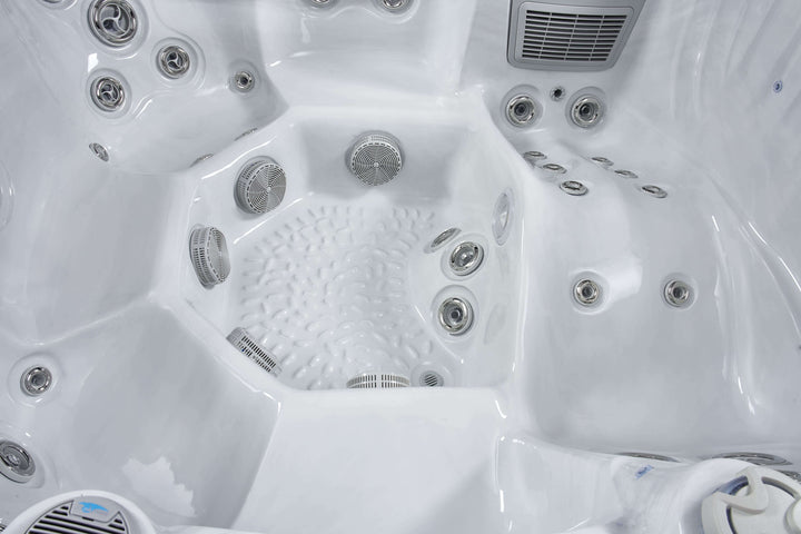 Close-up of Luso Spas The Vela Hot Tub white interior featuring multiple stainless steel jets and textured non-slip footwell.