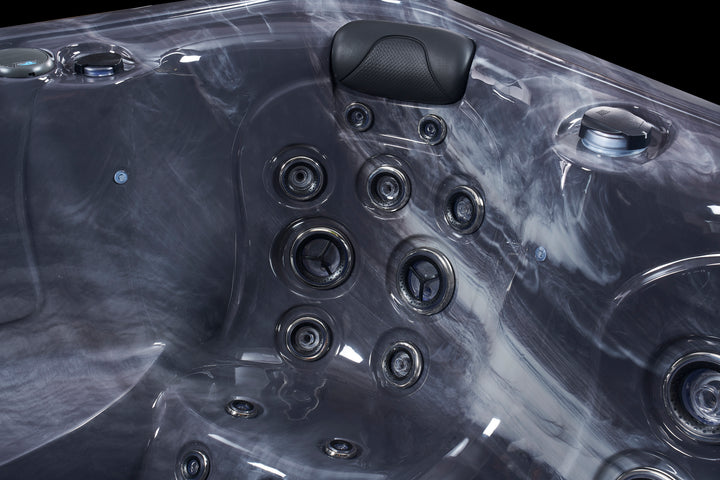 Close-up of Luso Spas The Vepo Hot Tub interior in grey marble finish showing massage jets and headrest.