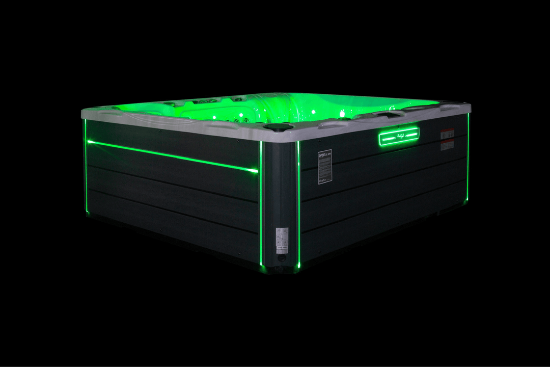Luso Spas The Maximus Hot Tub illuminated with green LED lights on a black background.