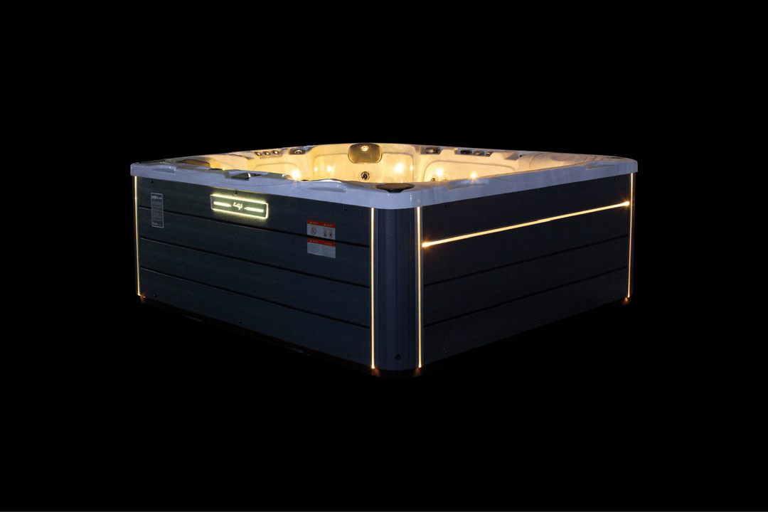 Luso Spas The Maximus Hot Tub illuminated with yellow LED lights on a black background.