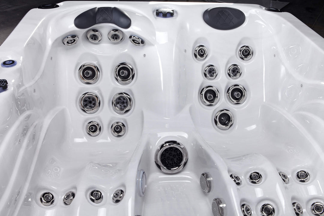 Interior close-up of Luso Spas Luso X300 Hot Tub in white acrylic finish showing premium hydrotherapy jets and cushioned headrests.