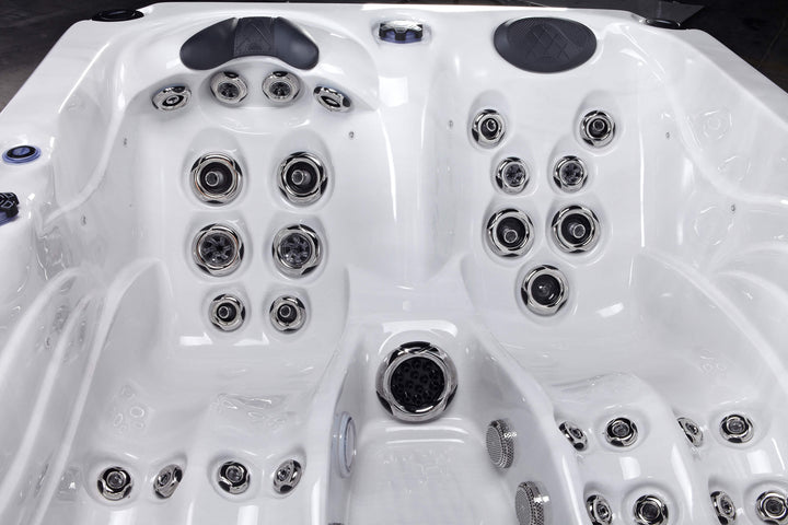 Interior close-up of Luso Spas Luso X300 Hot Tub in white acrylic finish showing premium hydrotherapy jets and cushioned headrests.