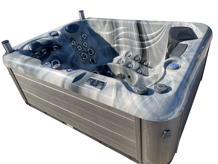 Angled exterior view of Luso Spas Luso X300 Hot Tub in dark marble finish and grey wood-effect sides with integrated control panel, on a white background.