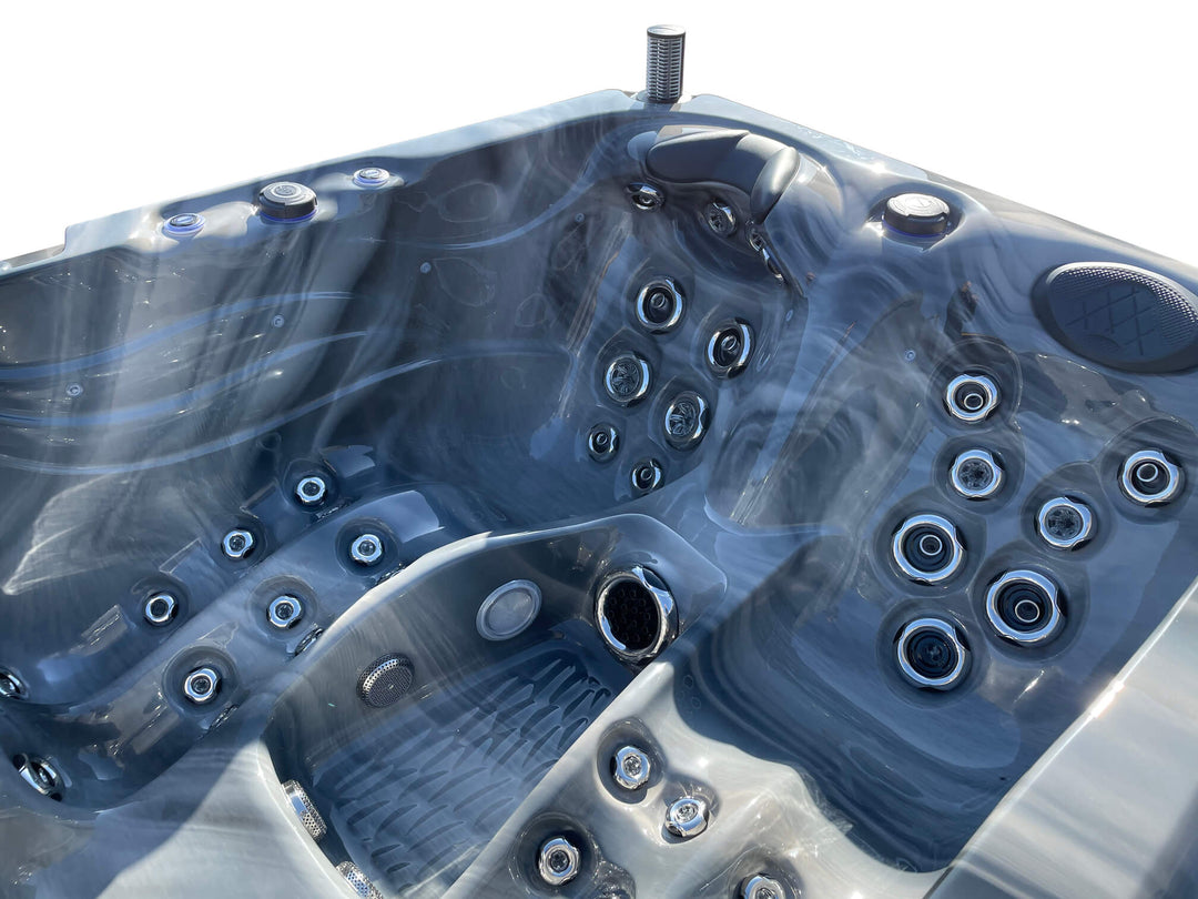 Close-up interior view of Luso Spas Luso X300 Hot Tub in dark marble finish highlighting multiple stainless steel jets and seating layout.