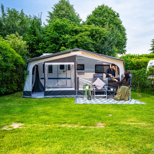 Monza 240 Awning shown from the front with a couple sitting outside