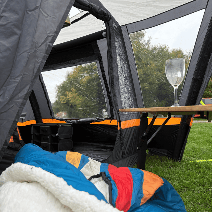 Inside view of the OLPRO Hanley Breeze awning with camping gear on a grassy field.