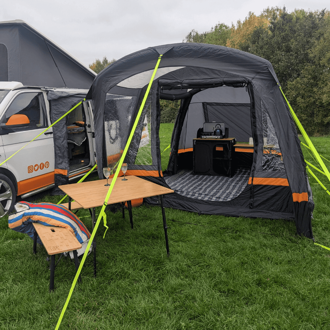OLPRO Hanley Breeze awning with outdoor table and chairs set up on a grassy field.