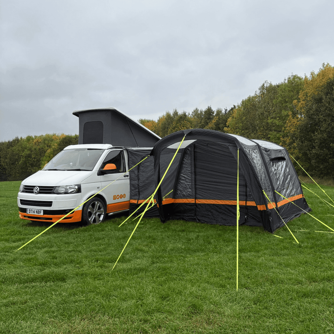 OLPRO Hanley Breeze awning setup beside a campervan on a grassy field.