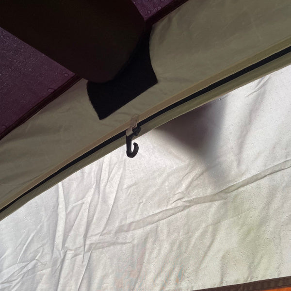 An Olpro Cubo Breee Air Awning shown with a close up on the inside hanging peg