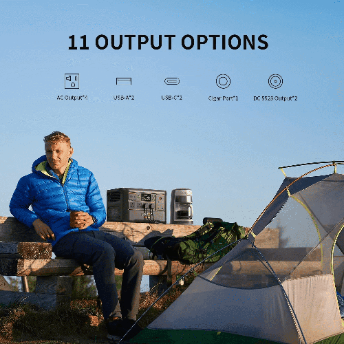 PECRON portable power station powering a coffee machine at a campsite beside a tent and backpack on a sunny outdoor.