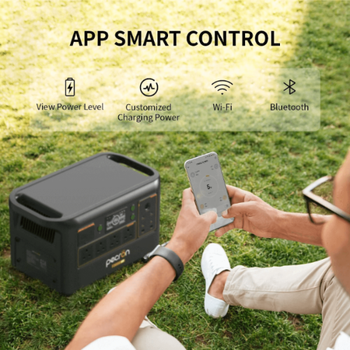 PECRON portable power station being controlled with a smartphone app outdoors on grass.