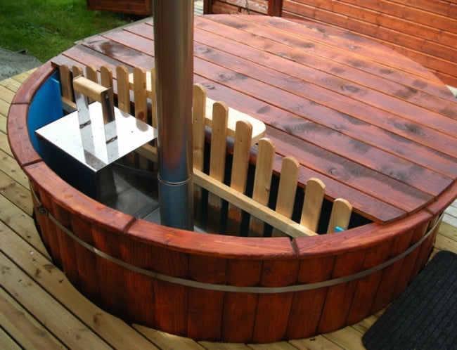 Top-down view of Viking Industrier Polypropylene hot tub with reddish wooden trim and stainless steel heater, partially covered on a wooden deck.