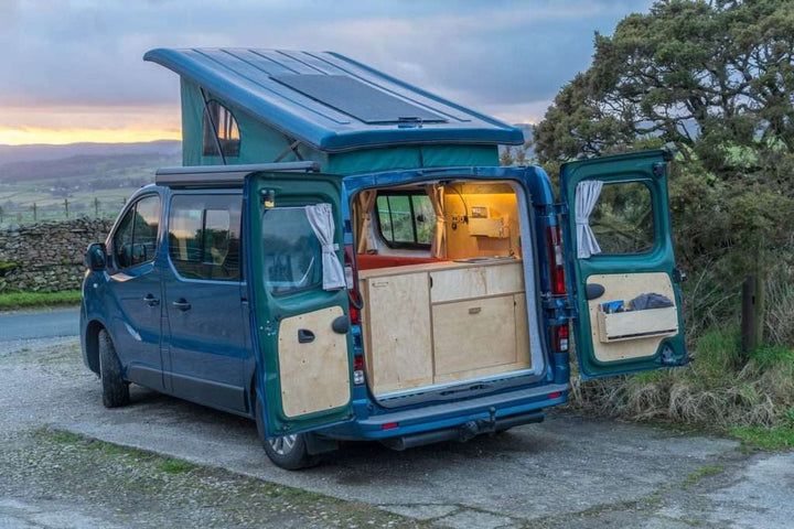 Campervan Ranger Kitchen Unit pop top campervan exterior view with rear doors open at countryside location.