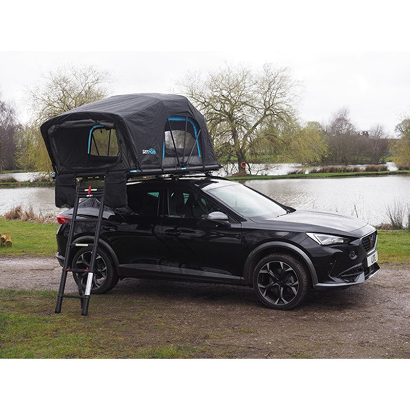 Black car fitted with Skypod Lite rooftop tent featuring blue trim and ladder access.