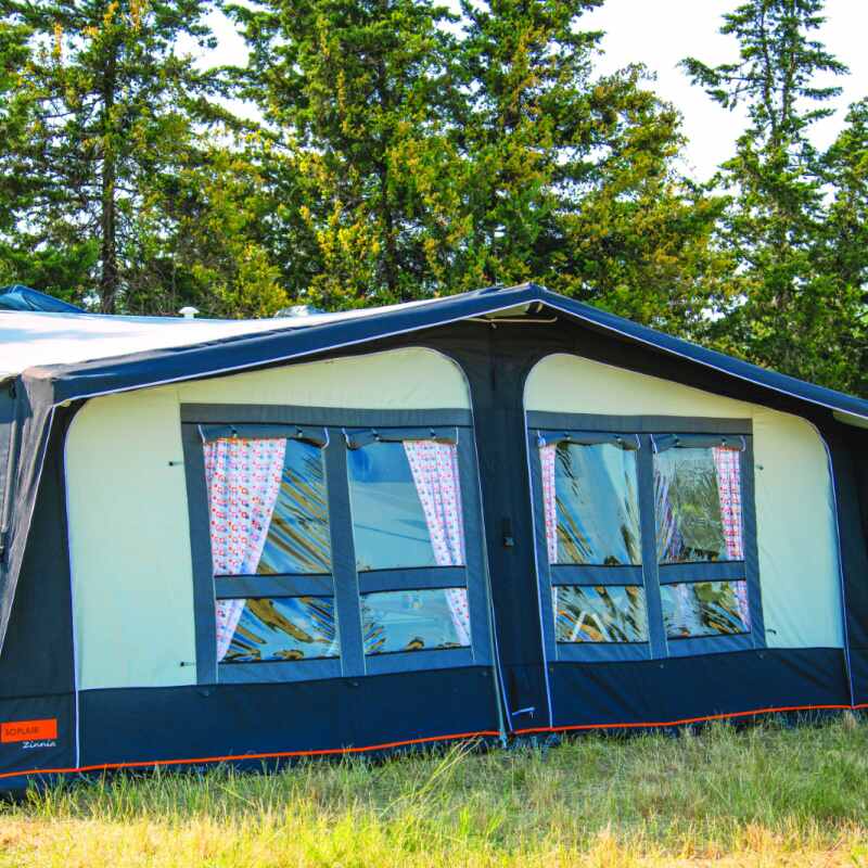 A Soplair Zinnia Air traditional caravan awning in a field shown from the front