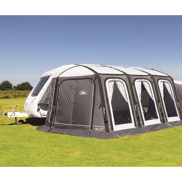 Sunncamp Esteemed Air Awning shown attached to white caravan displaying three front panels and grey inflatable frame structure on grass