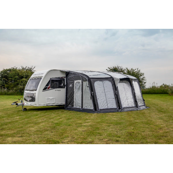 Sunncamp Inceptor 390 Air Awning shown in complete setup configuration attached to white caravan on grass