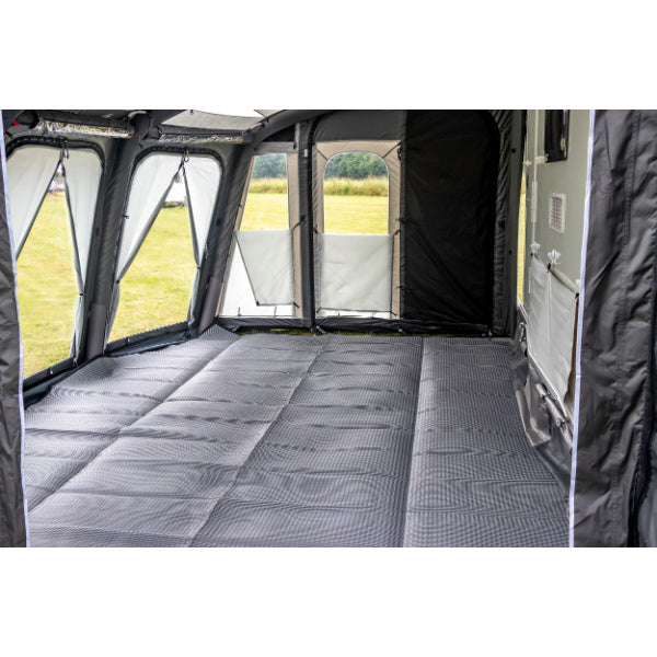 Sunncamp Inceptor Air Awning interior view showing grey cushioned flooring and panel windows