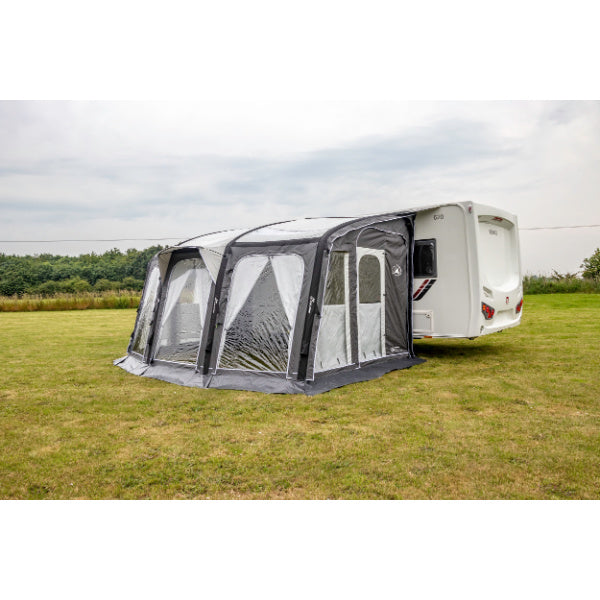 Sunncamp Inceptor Air full awning setup on grass field with caravan attachment visible