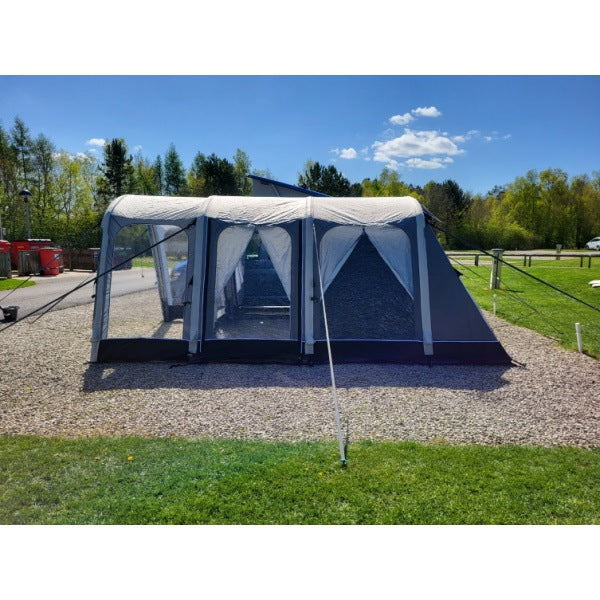 Sunncamp Motor Air Awning photographed from distance showing complete setup in campsite environment