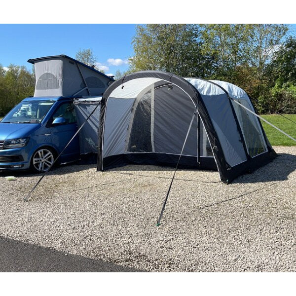 Wide angle view of the Sunncamp Swift Motor Air in a natural camping environment with trees in background