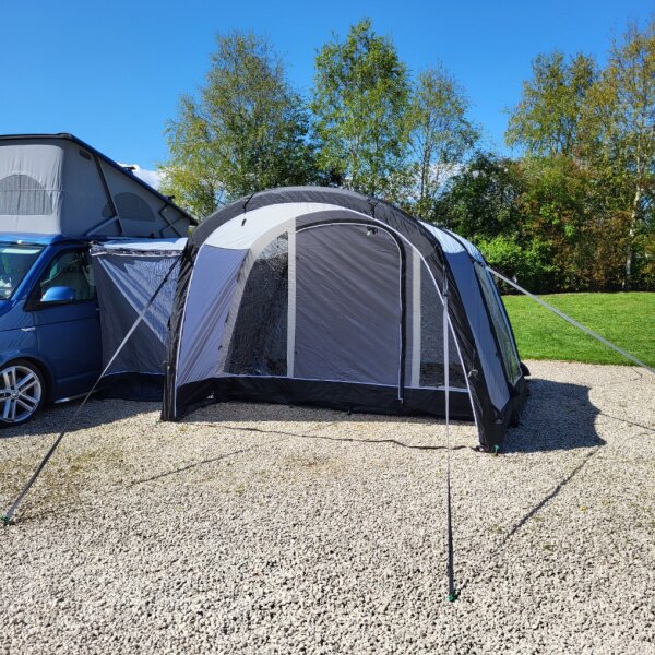 Mid-range view of the Swift Motor Air MID demonstrating the awning's integration with the campsite environment