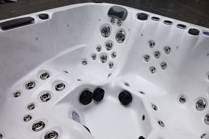 The Aspen Hot Tub interior with multiple stainless steel jets and headrests .