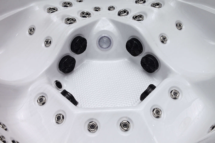 Close-up view of The Aspen Hot Tub interior showing hydrotherapy jets and textured white base.