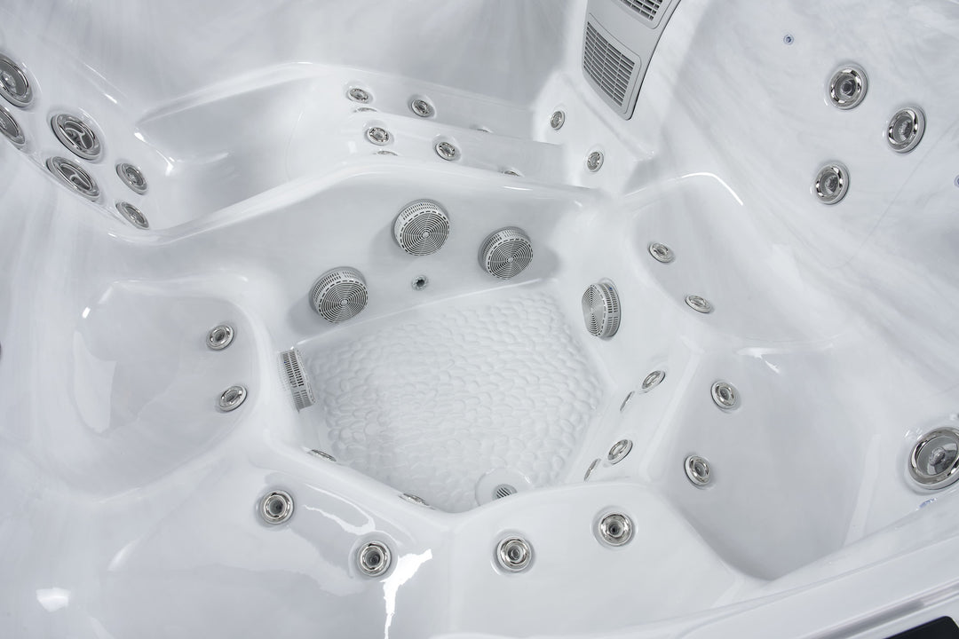 Interior close-up of the Luso Spas The Hydra Hot Tub showing textured footwell and surrounding jets on a black background.