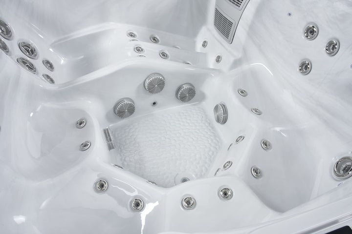 Interior close-up of the Luso Spas The Hydra Hot Tub showing textured footwell and surrounding jets on a black background.