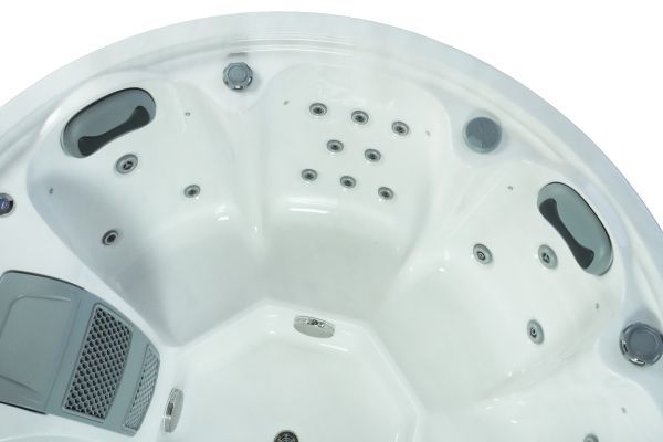 Close-up interior of Luso Spas The Orb Hot Tub in white acrylic finish with cushioned headrests and multiple hydrotherapy jets.