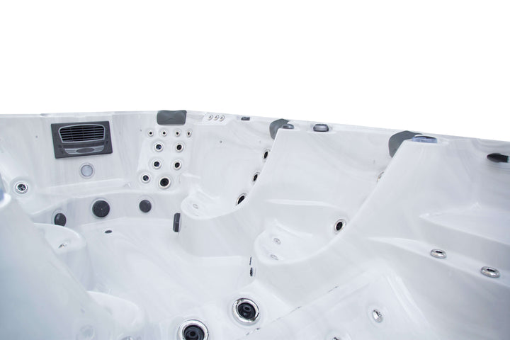 Interior angled view of the Luso Spas The Party Pool Hot Tub in white marble finish on a white background, showing detailed seating and jets.