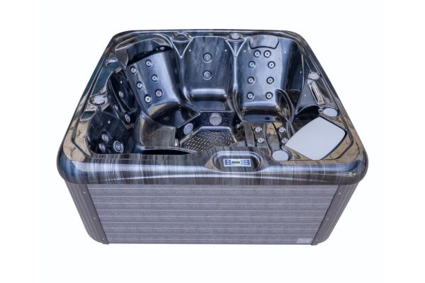 Front view of Luso Spas The Platinum 2 Hot Tub in black marble finish featuring lounge seats and hydrotherapy jets on a white background.