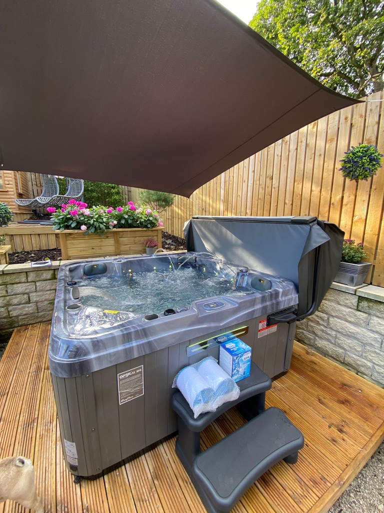 Luso Spas The Venice 2 Hot Tub placed outdoors on a wooden deck with canopy shade and garden background.