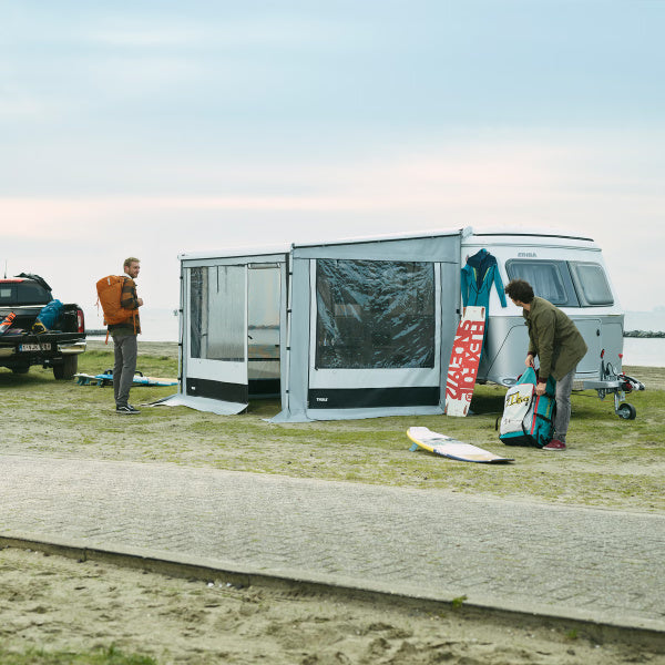 A Thule Residence Awning for Eriba Troll with two men standing either side