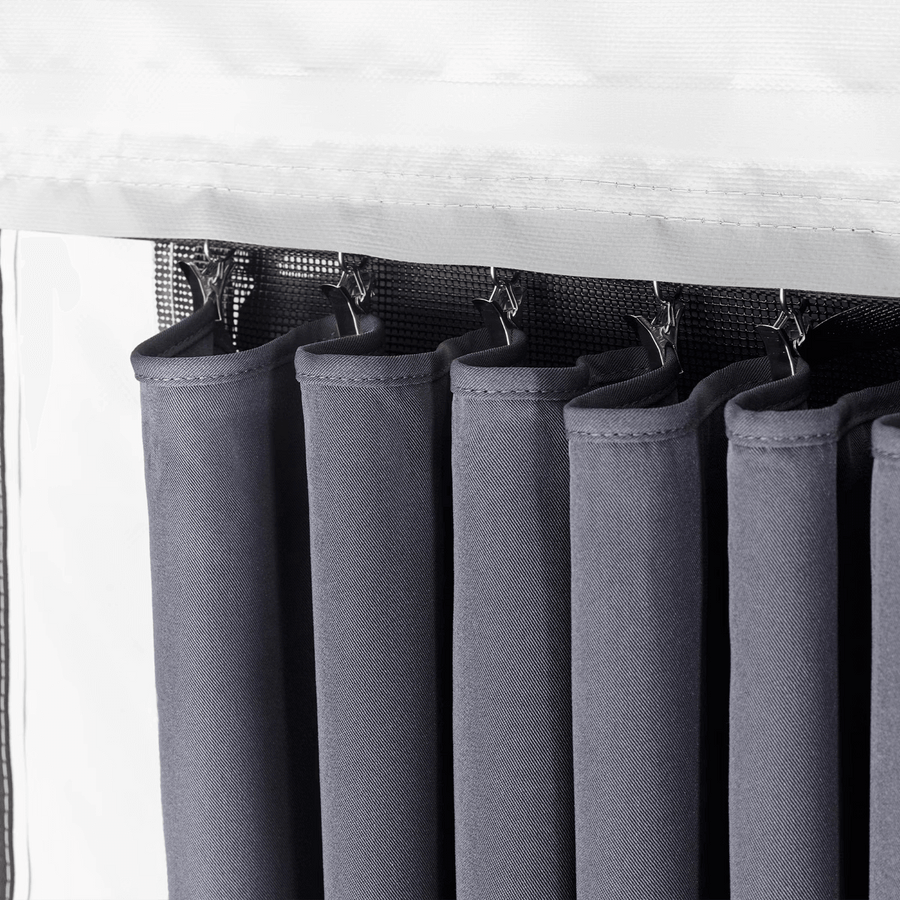 Close-up of Thule awning room curtains hanging on hooks.