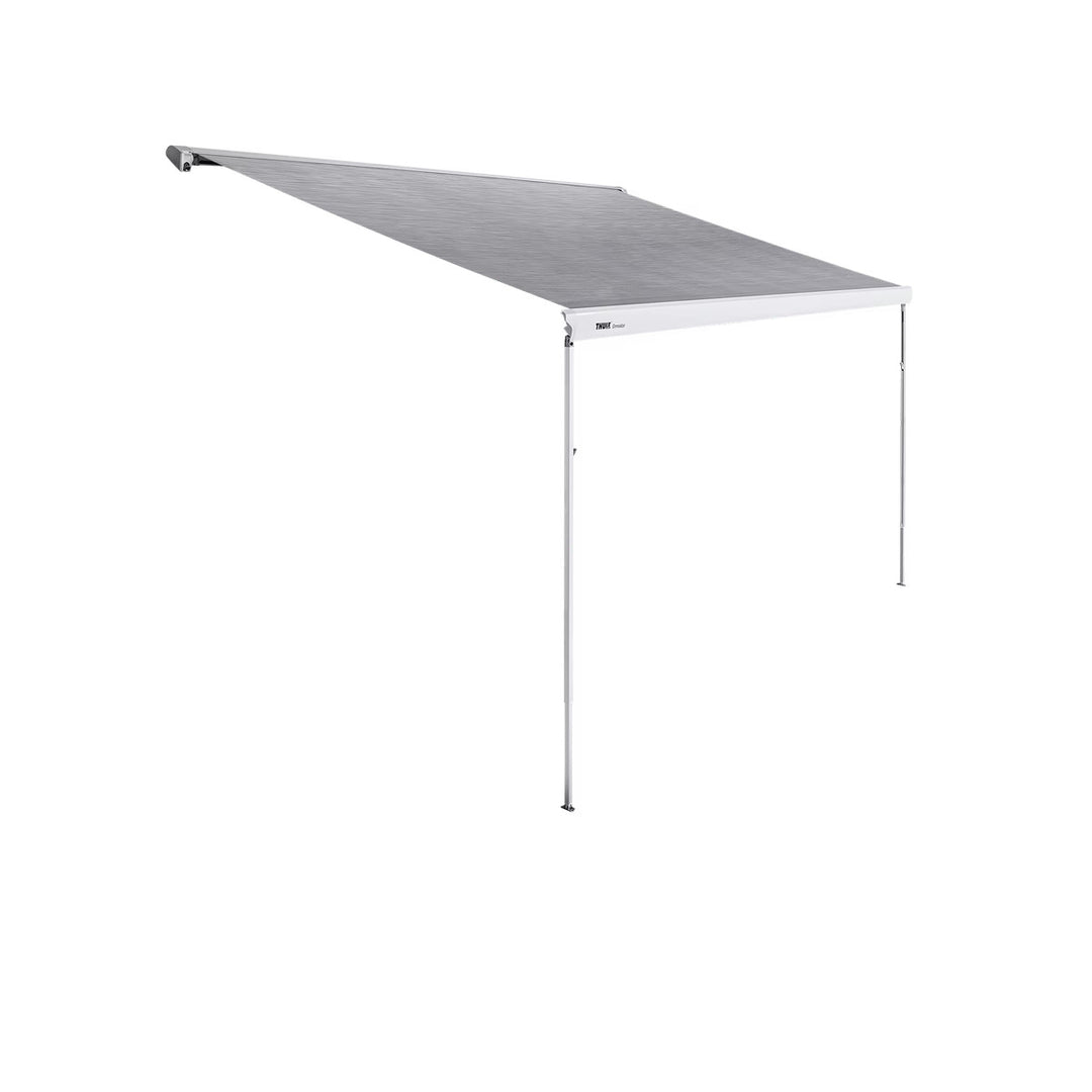 Thule awning fully extended with support legs on a white background.