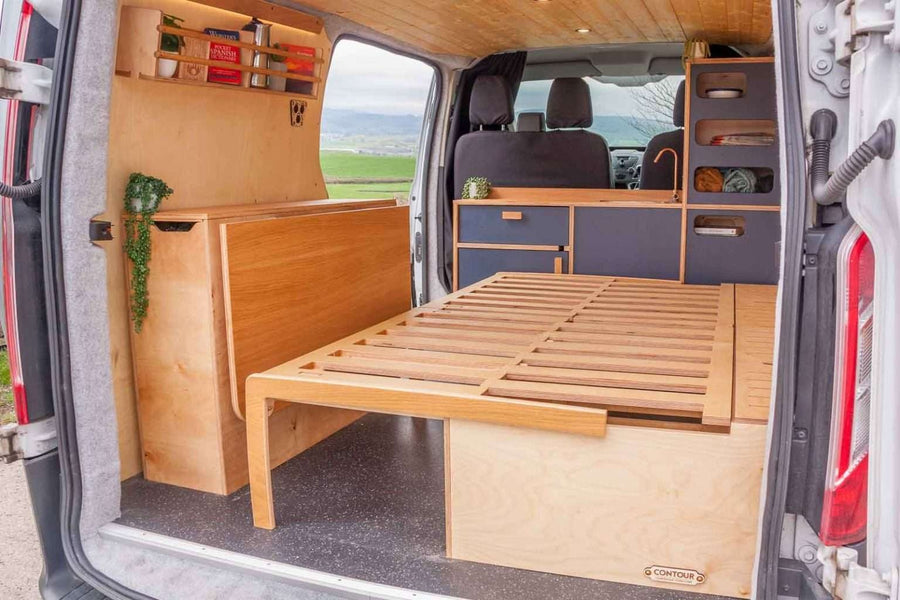Campervan “Topo” Sofa-Bed configured as a double bed with striped cushions inside a modern campervan conversion.