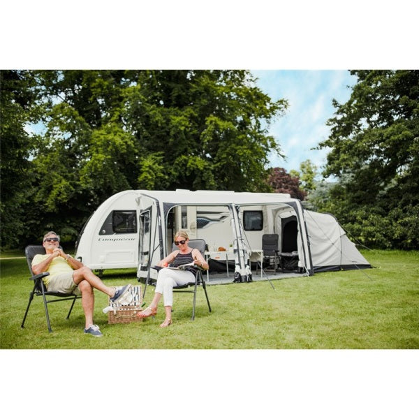 A couple sitting in chairs in front of a Vango Balletto 390 Elements Shield 