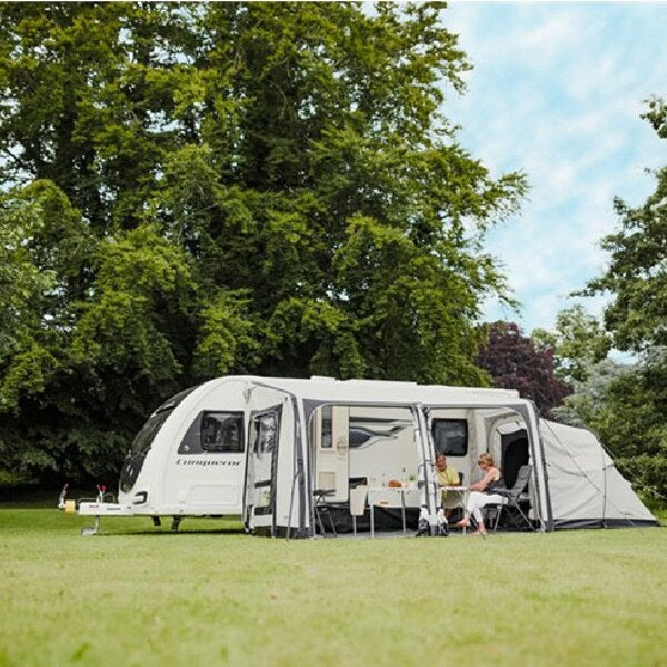 A couple sitting inside a Vango Balletto Air 390 without panels