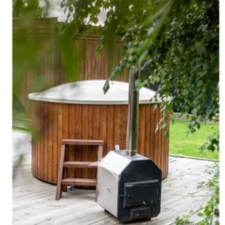 Image of a Viking Industrier Fiberglass Hot Tub with external wood-fired heater and wooden steps, partially obscured by overhanging tree leaves.